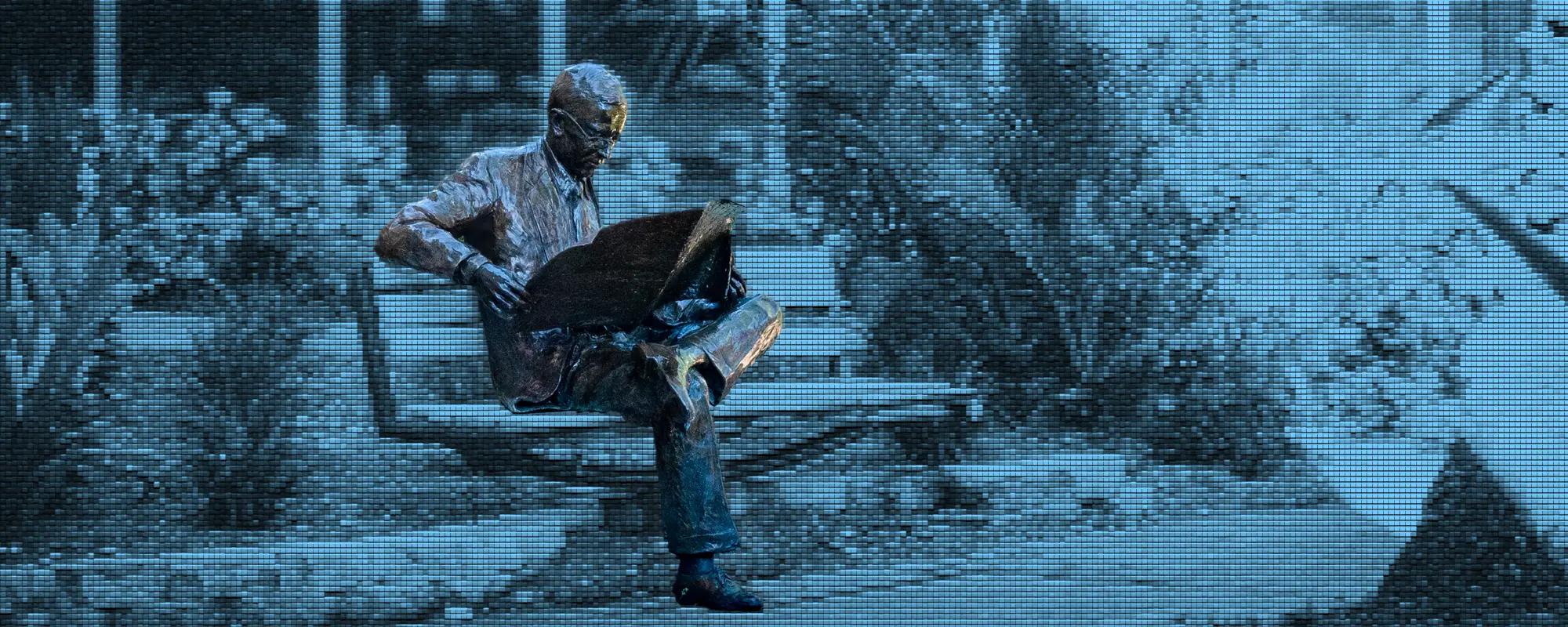 Statue of man reading at poynter institute st. petersburg
